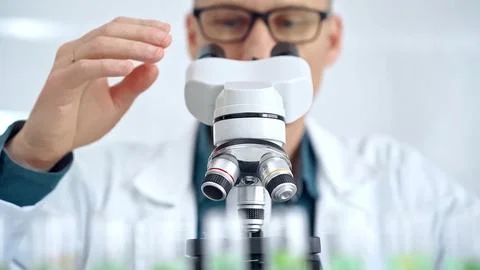 Man scientist with protective glasses using microscope in laboratory 스톡 사진