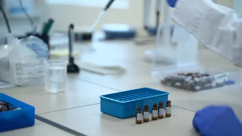 Man scientist testing drugs using reagents at table in pharmaceutical laboratory Stock-Footage 128295030