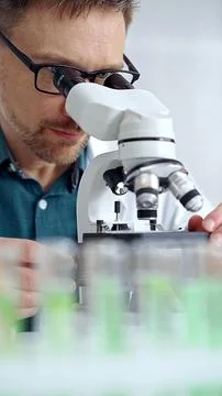 Man scientist using microscope in laboratory. Microbiology science concept 스톡 사진