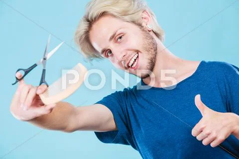 Man with scissors and comb creating new coiffure Stock Photos