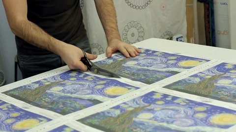 A man with scissors cuts paper Video stock 69775987