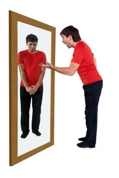 Man scolding himself in a mirror Stock Photos
