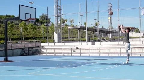 Man scoring a 3 point basket Stock Footage 64038137