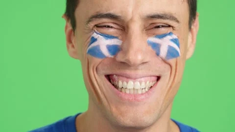 Man with a scottish flag painted on the face smiling Stock Footage 253114919