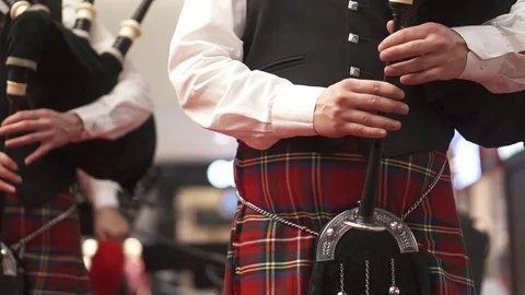 A man in a Scottish kilt is playing on a bagpipe. Concert. Bagpipes. Stock Footage 84043003