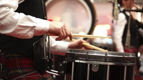 A man in a Scottish kilt plays the drum. Concert. Bagpipes. Drummer Stock Footage 84042984