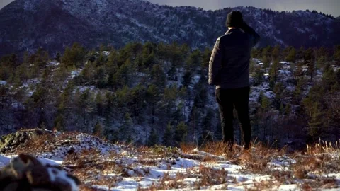 Man scouting scenery from high up on mountain Stock Footage 233513932