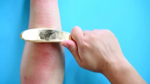 Man scraping his arm by a copper scratcher Stock Footage 142115536