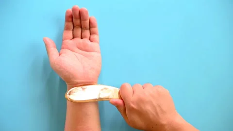 Man scraping his arm by scratcher as a traditional Chinese medical treatment Stock Footage 141904053