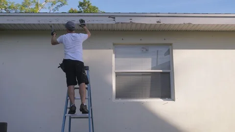 Man Scraping Old Paint before Using Paint Gun Stock Footage 95485301