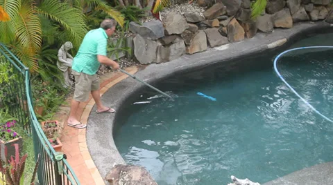 Man Scraping Pool Stock Footage 34498582