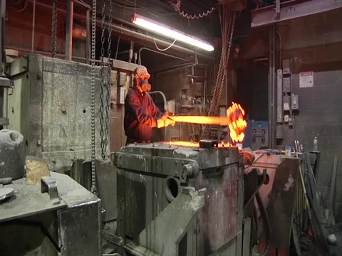 Man Scraps Big Chunk Out Of Furnace Stock Footage 1089641