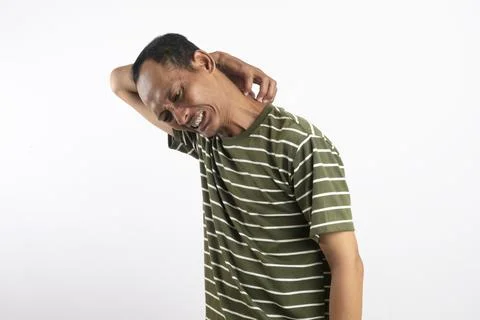 A man scratching the back of his neck and showing a pained facial expressio.. Stock Photos