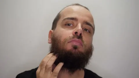 Man scratching his beard Stock Footage 169769814