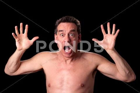 Man screaming in horror on black background Stock Photos