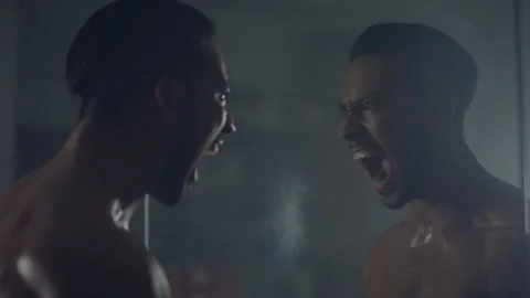 Man screaming while looking at himself in the mirror Stock Footage 279845144