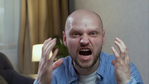 A man screams and waves his arms looking at camera. The concept of irritability Stock Footage 242599634