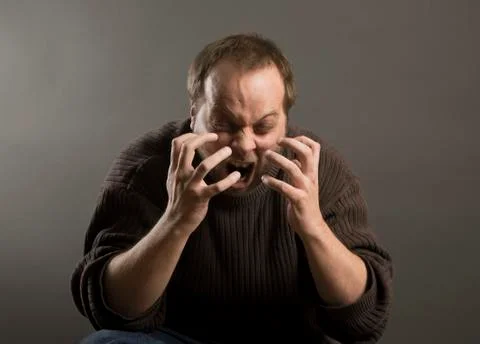 Man screeming out loud with aggressive facial expression Photos