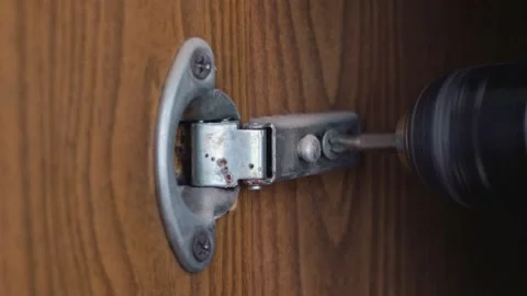 A man with a screwdriver disassembles old furniture Video stock 159467752