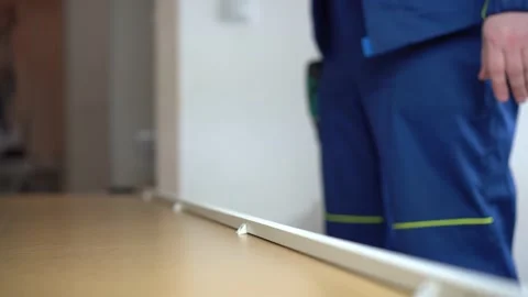 A man screwing a countersunk screw with a screwdriver, assembling a cabinet Stock Footage 202302991