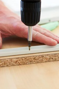 Man screwing screws Stock Photos