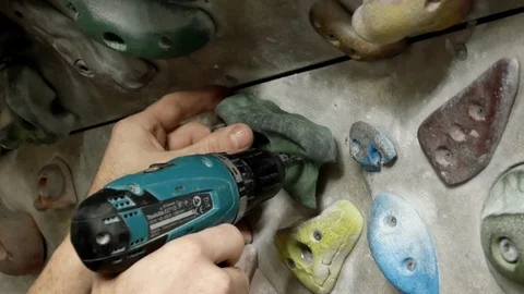 Man screws handhold Stock Footage 103663258