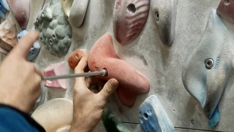 Man screws handhold Stock Footage 103663957