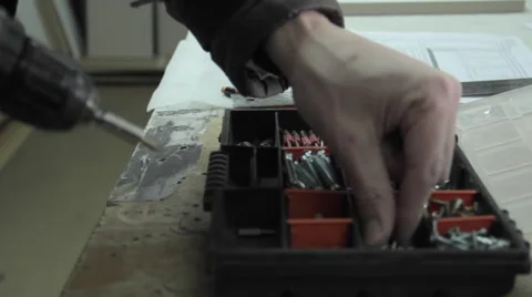 Man screws hinge into cabinet Stock-Footage 63209210