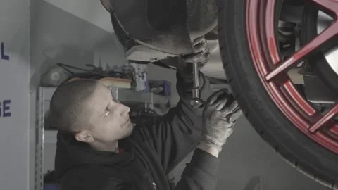 Man screws screw on the car Stock Footage