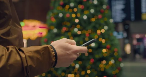 Man scroll through phone at central train station Stock Footage 144002461