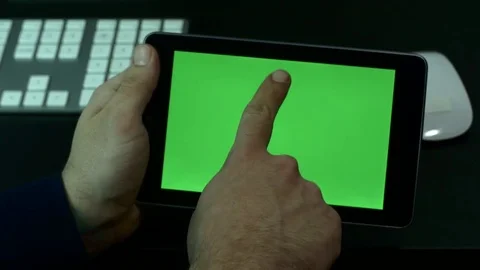 Man Scrolling Up And Down Pages On His Tablet Computer, Green Screen Stock Footage 73784600