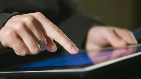 Man scrolling and scaling On His Tablet Video stock 80170935