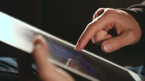 Man scrolling and scaling On His Tablet Video stock 80171069