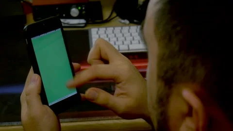 Man scrolling on Apple iPhone 6s with green screen Stock Footage 241085647