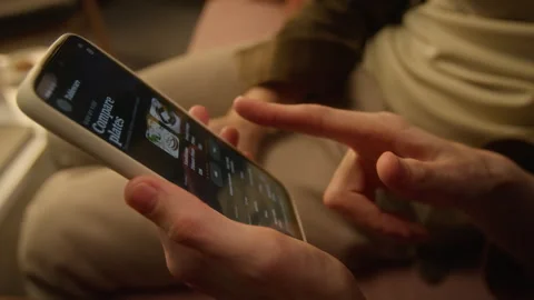 Man Scrolling E-commerce App on Smartphone for Online Shopping Stock Footage 344875102