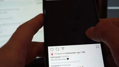 A man scrolling instagram feed during blackout tuesday. Black squares on screen Stock Footage 131648540
