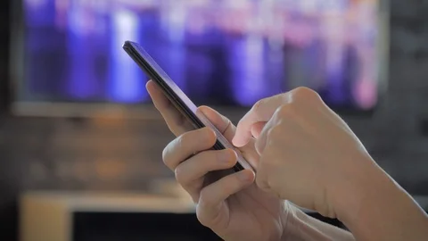 Man scrolling on the internet on a smartphone Stock Footage 109459115