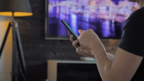 Man scrolling on the internet on a smartphone Stock Footage 109459159