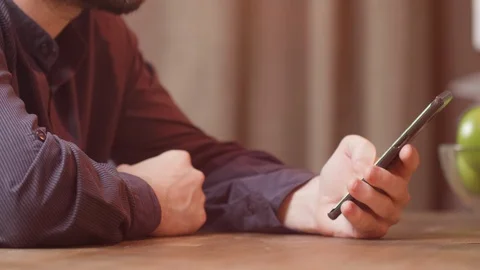 Man scrolling over a text on his smartphone Video stock 106702144