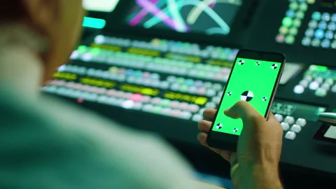 A man scrolling the phone. Green screen. Camera over the shoulder. TV Switch Video stock 199221007