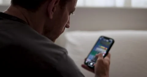 Man Scrolling on smartphone. guy casually scrolling through social media Stock Footage 277969556