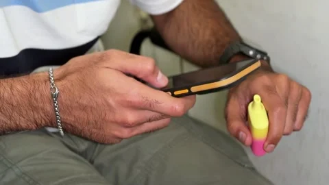 Man Scrolling Smartphone Holding Yellow Pink Vape Stock Footage 341667432
