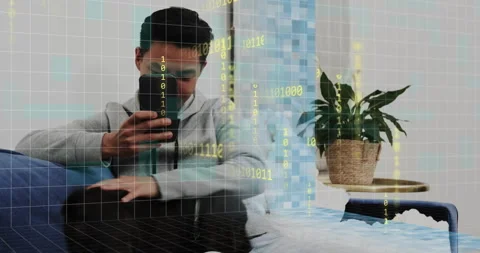 Man scrolling smartphone screen causing tech grid, binary overlay in living room 스톡 동영상 316120028