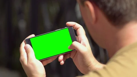 Man scrolling up through information on his mobile Video stock 112153161