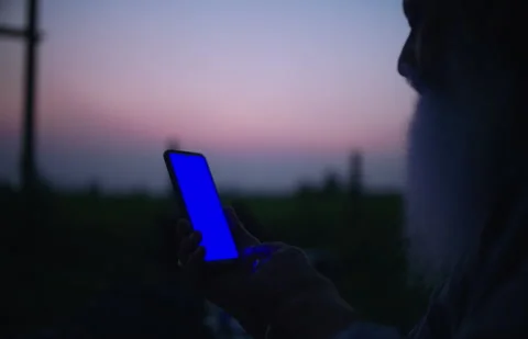 Man scrolling through phone with blue screen Stock Footage 295606603