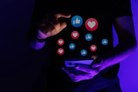 Man scrolling through social network and consumed by Social Medias Validation Stock Photos