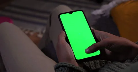 Man scrolling thumb on mobile phone green screen at home Stock Footage 147361859