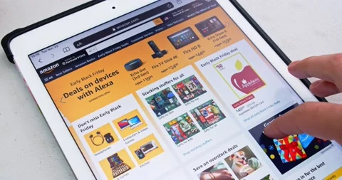 Man scrolls Amazon website on iPad Stock Footage 167753084