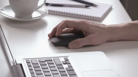 Man scrolls and clicks on a black mouse Stock Footage 62723786