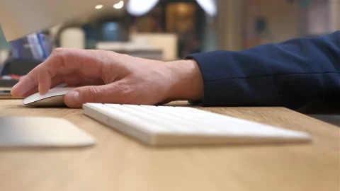 The man scrolls and clicks the white mouse. Office gadgets with modern design. Stock Footage 234167769